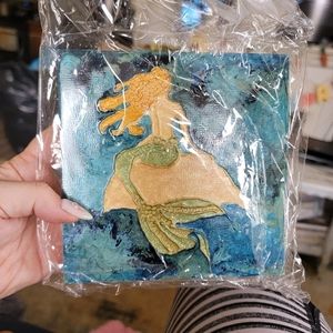 Mermaid painting on wood.